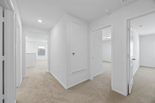 corridor with light colored carpet