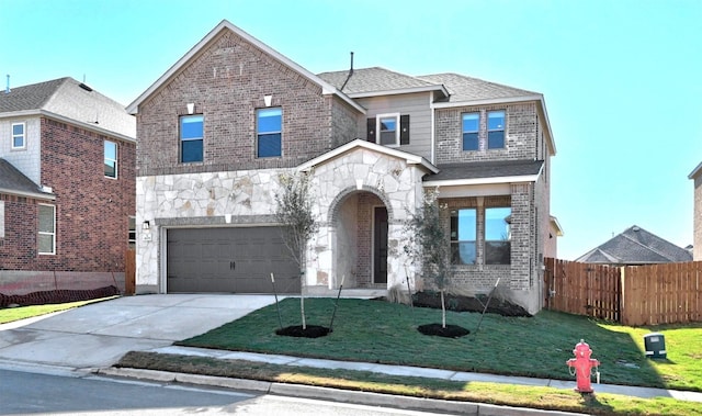 view of front of house featuring a front yard and a garage