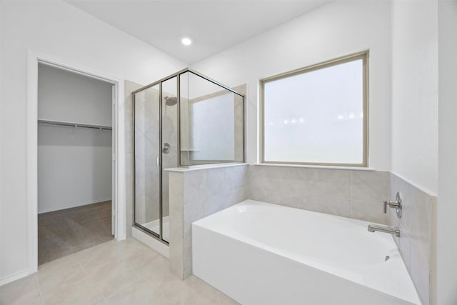 bathroom with tile patterned floors and plus walk in shower