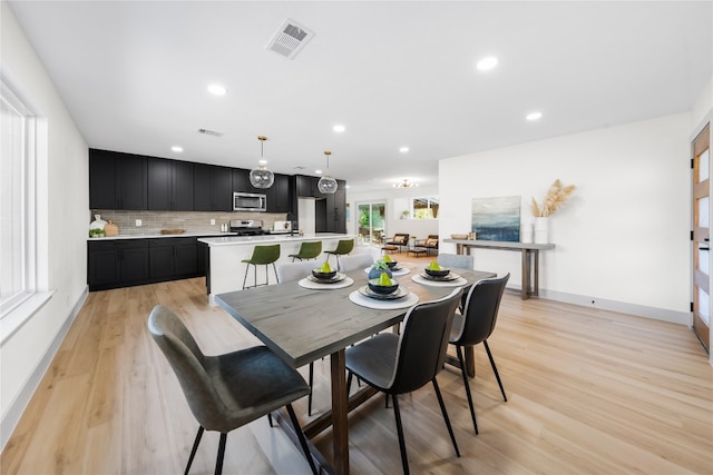 dining space with light hardwood / wood-style flooring