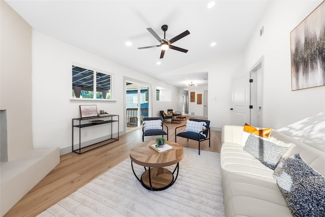 living room featuring light hardwood / wood-style floors and ceiling fan