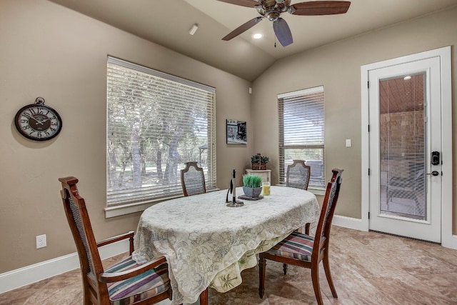 tiled dining space with vaulted ceiling and ceiling fan