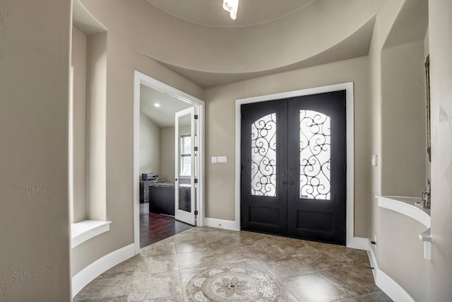 foyer with wood-type flooring and french doors