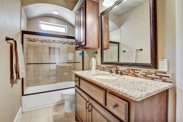 full bathroom with vanity, toilet, backsplash, combined bath / shower with glass door, and tile patterned flooring