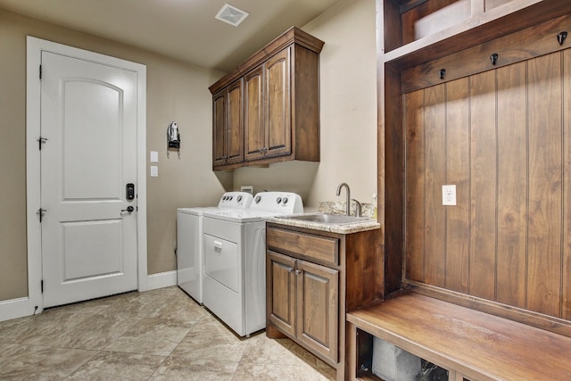 laundry room featuring cabinets, sink, and washing machine and dryer