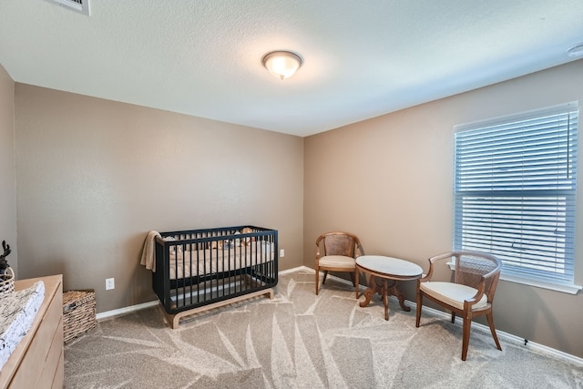 carpeted bedroom featuring a crib