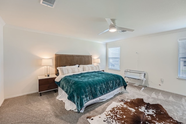 carpeted bedroom featuring ceiling fan and ornamental molding