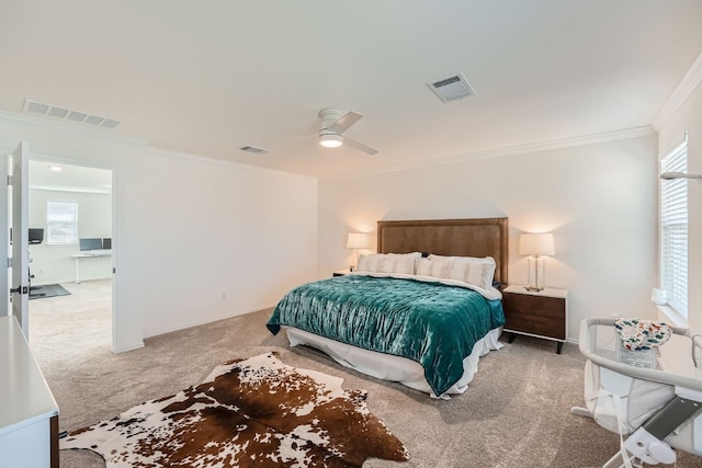 carpeted bedroom with ceiling fan and ornamental molding