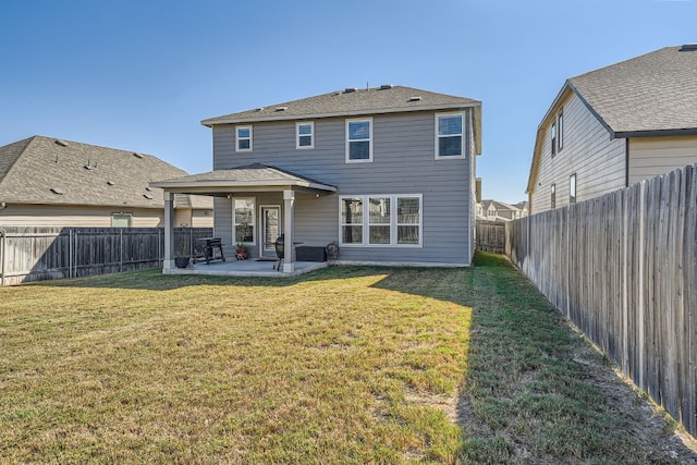 back of house with a patio area and a yard