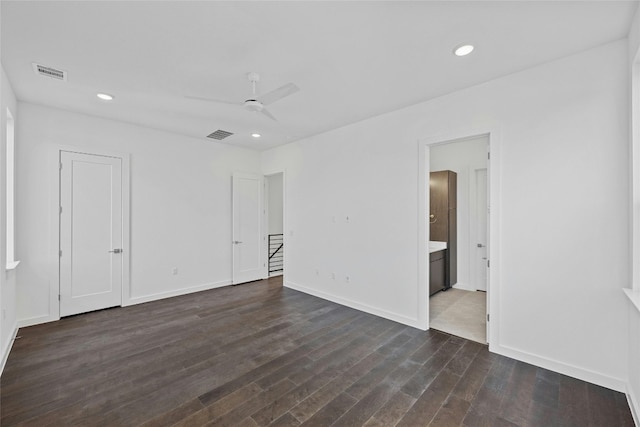 empty room featuring ceiling fan and dark hardwood / wood-style flooring