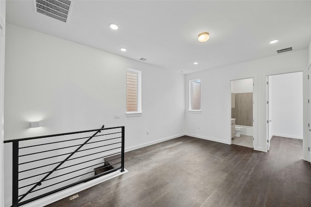 unfurnished room featuring dark wood-type flooring