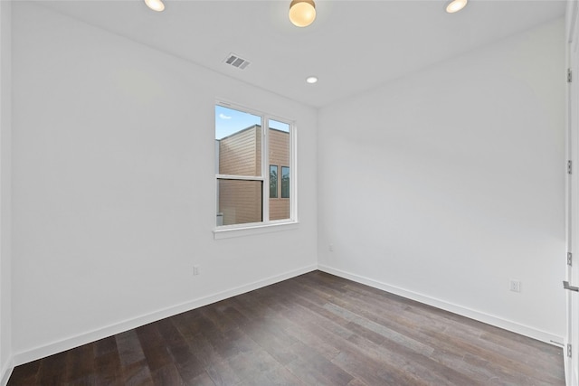 spare room featuring dark hardwood / wood-style flooring