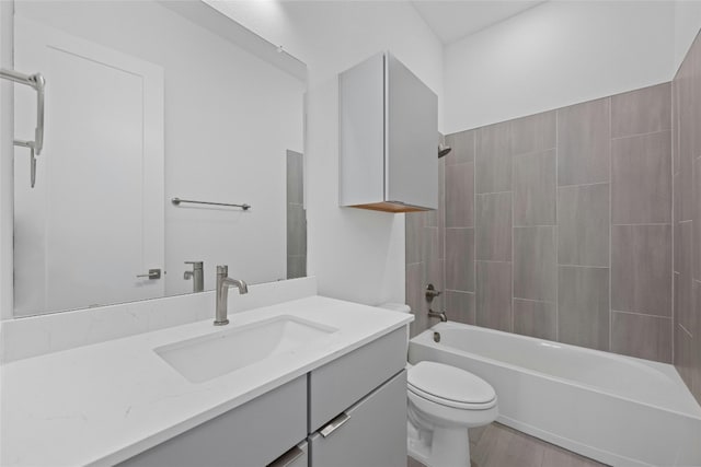 full bathroom with hardwood / wood-style flooring, vanity, toilet, and shower / bathing tub combination