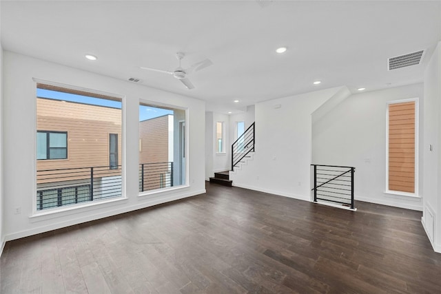 spare room with dark wood-type flooring and ceiling fan