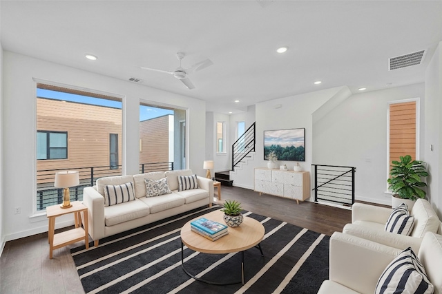 living room featuring dark hardwood / wood-style floors and ceiling fan