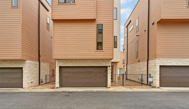 6821 Wolfcreek Pass Unit 12, Austin, TX 78749 - view of front of home featuring stone siding and an attached garage