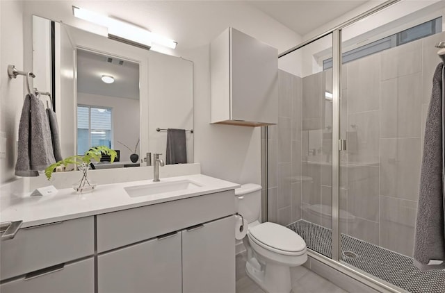 6821 Wolfcreek Pass Unit 12, Austin, TX 78749 - full bathroom featuring vanity, toilet, a shower stall, and tile patterned floors