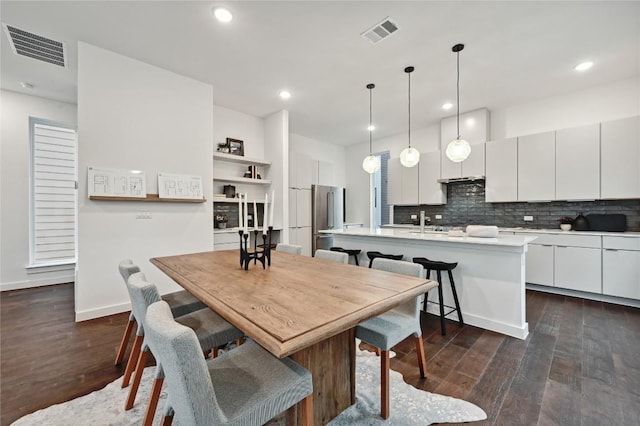 6821 Wolfcreek Pass Unit 12, Austin, TX 78749 - dining room featuring dark wood-style flooring and recessed lighting
