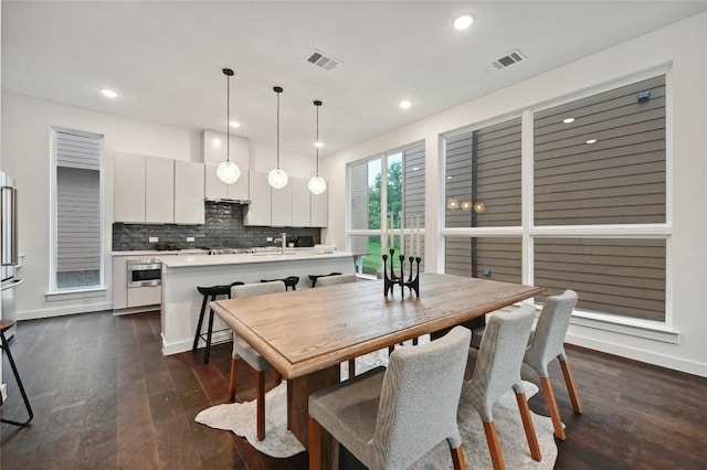 6821 Wolfcreek Pass Unit 12, Austin, TX 78749 - dining space featuring dark wood-style floors and recessed lighting