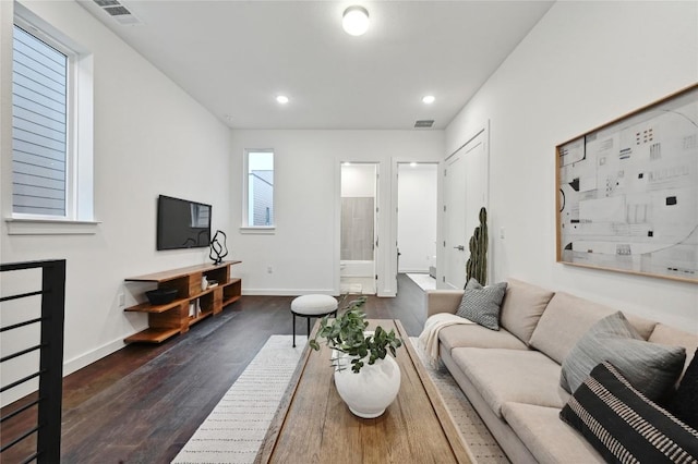 6821 Wolfcreek Pass Unit 12, Austin, TX 78749 - living area featuring dark wood-style flooring, baseboards, and recessed lighting
