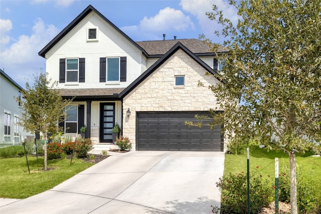 view of front of property with a garage and a front yard