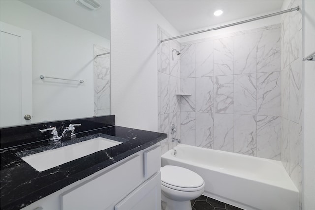 full bathroom featuring toilet, tiled shower / bath combo, tile patterned floors, and vanity