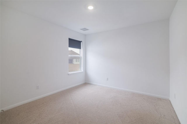 empty room featuring light carpet