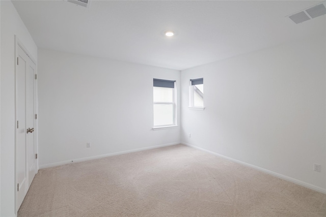 spare room with light colored carpet