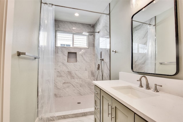 bathroom featuring vanity and a shower with shower curtain