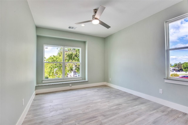 empty room with light hardwood / wood-style flooring and ceiling fan