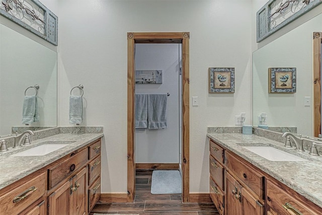 1104 Hill Circle W Dr, Granite Shoals, TX 78654 - full bathroom featuring two vanities and wood finished floors