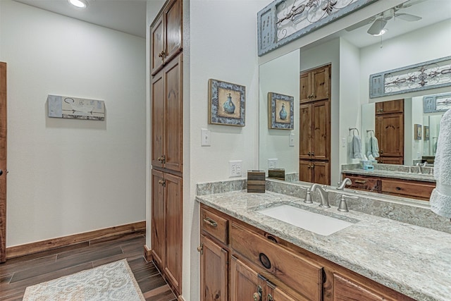 bathroom featuring ceiling fan, vanity, and hardwood / wood-style floors