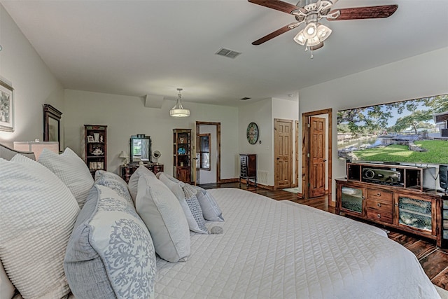 bedroom with ceiling fan and hardwood / wood-style flooring