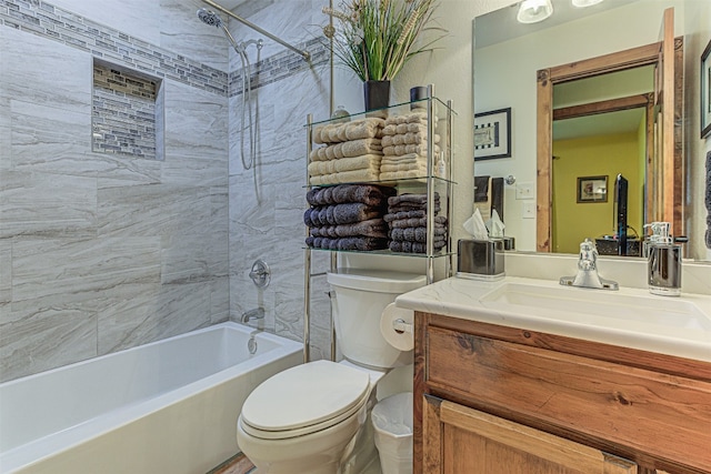 full bathroom featuring tiled shower / bath combo, vanity, and toilet