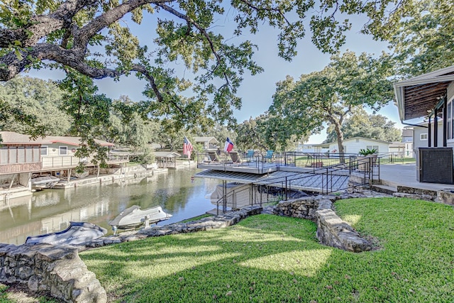 view of dock featuring a water view and a yard