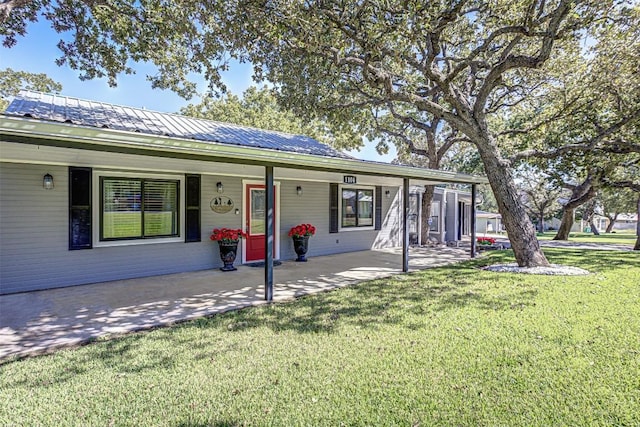 1104 Hill Circle W Dr, Granite Shoals, TX 78654 - ranch-style home with a front yard, a metal roof, and covered porch