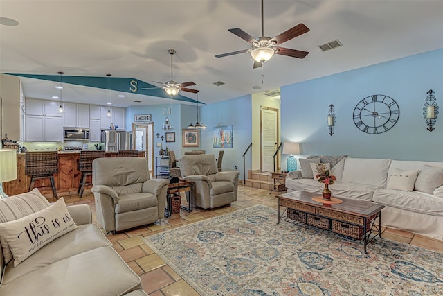 living room featuring ceiling fan and lofted ceiling