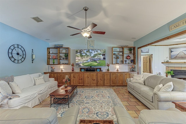 living room with ceiling fan and vaulted ceiling