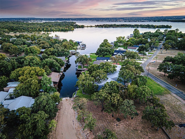 aerial view at dusk with a water view