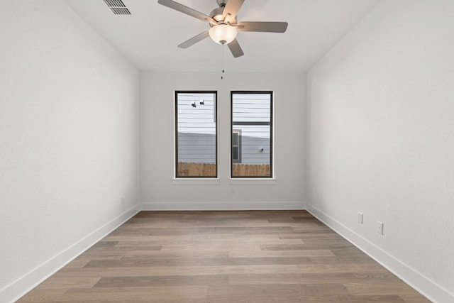 empty room with ceiling fan and light hardwood / wood-style floors