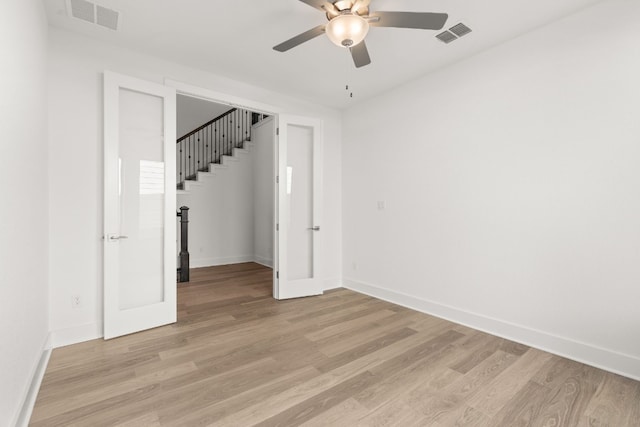 spare room with ceiling fan and light wood-type flooring