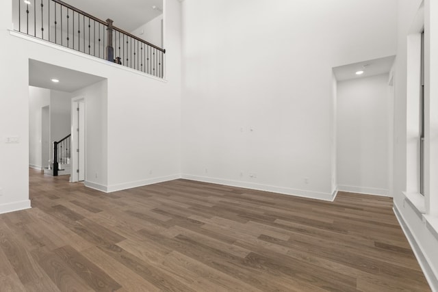 spare room with wood-type flooring and a high ceiling