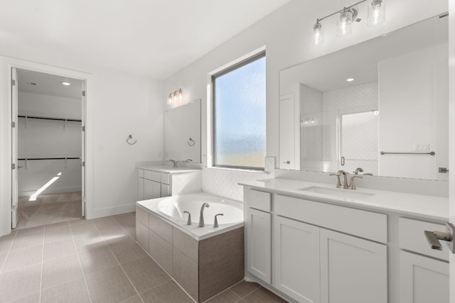 bathroom featuring tile patterned flooring, vanity, and independent shower and bath