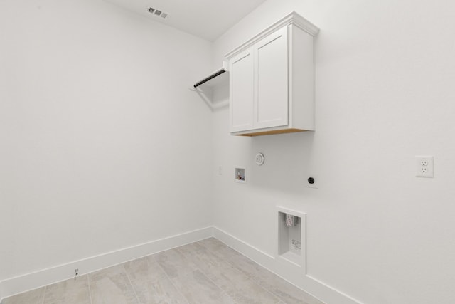 washroom featuring electric dryer hookup, hookup for a washing machine, hookup for a gas dryer, and cabinets