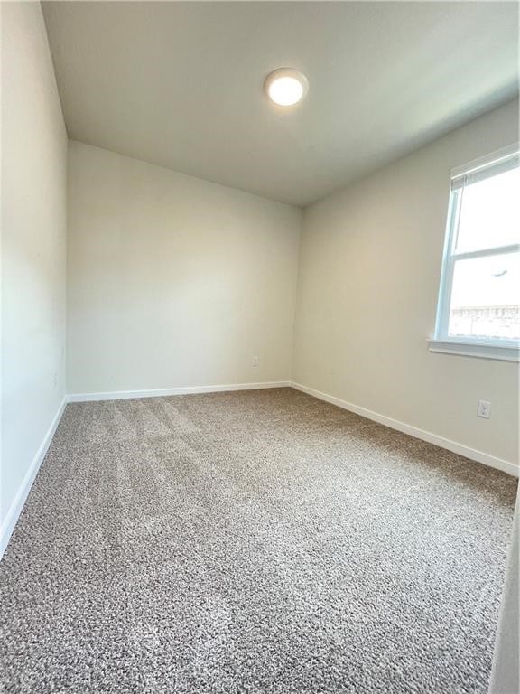 spare room featuring carpet floors