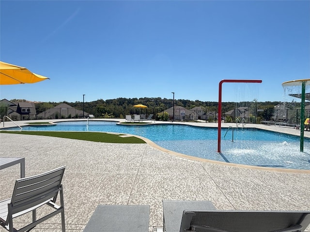 view of swimming pool with a patio area