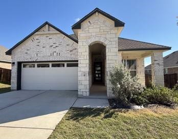 view of front of property with a front yard and a garage