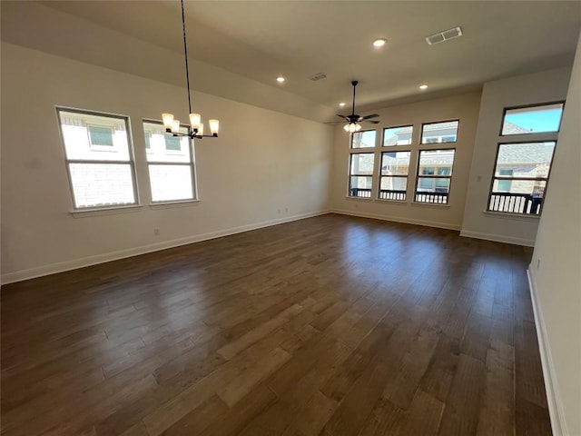 unfurnished room with dark wood-type flooring and ceiling fan with notable chandelier