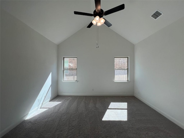 carpeted spare room featuring ceiling fan and high vaulted ceiling