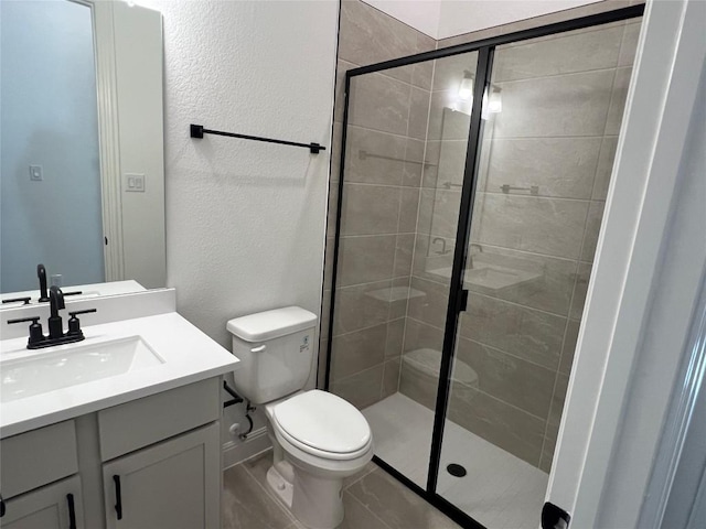 bathroom featuring vanity, toilet, and walk in shower